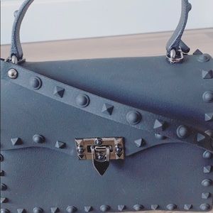 Rock stud purses with crossbody strap.